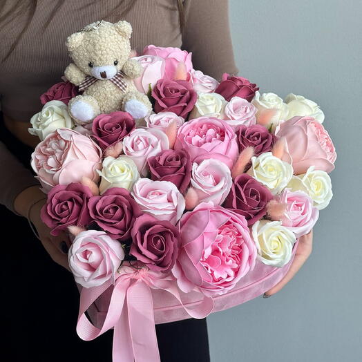 A heart with soap flowers and a teddy bear