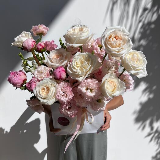 Box with white garden fragrant roses and eustoma