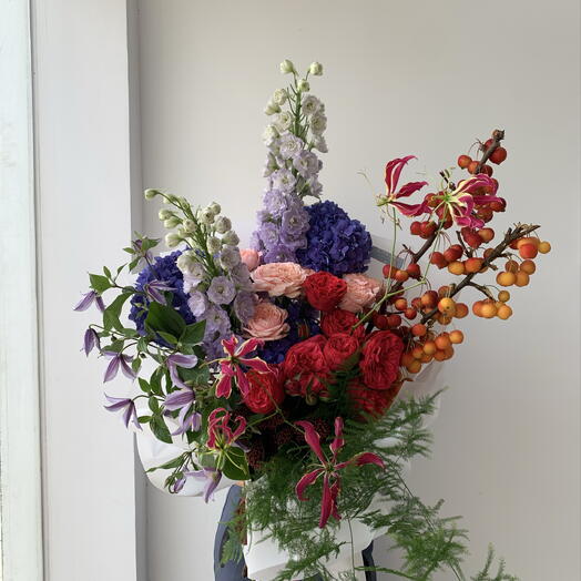 Colourfully bouquet with apples, garden red roses, clematis and hydrangeas