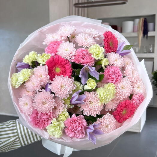 A wildflower bouquet with a chrysanthemum and a clematis.