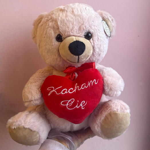 Cream teddy bear with a heart