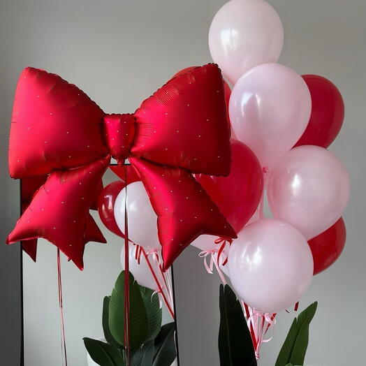 Set of pink and red balloons with a bow
