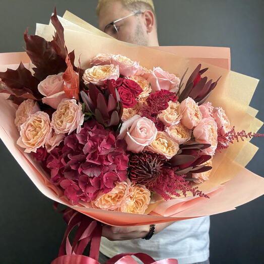 An autumn bouquet with peony-like roses and exotic flowers