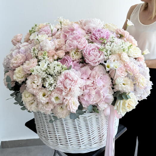 Big white basket with hydrangea, peony, garden rose