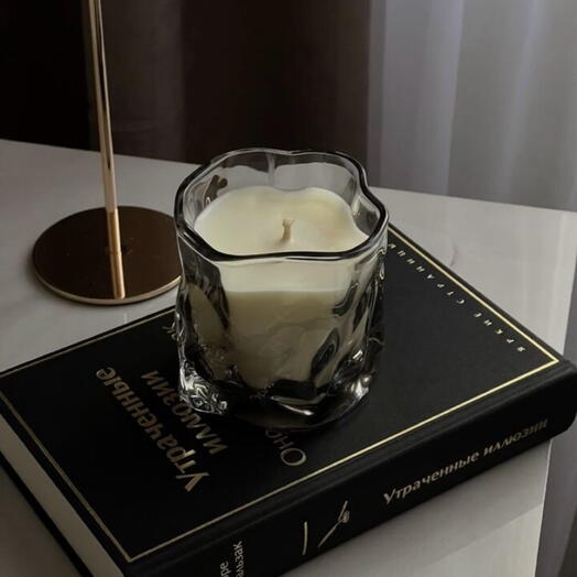 Scented candle in a crumpled glass