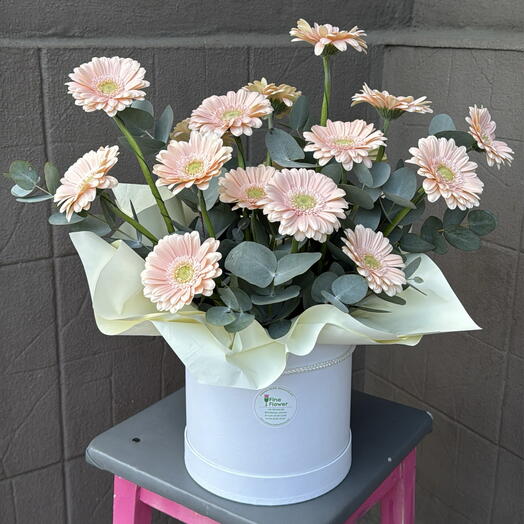 A box with gerberas and eucalyptus
