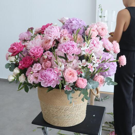 Garden flowers in big basket with hydrangea, peonies, garden roses