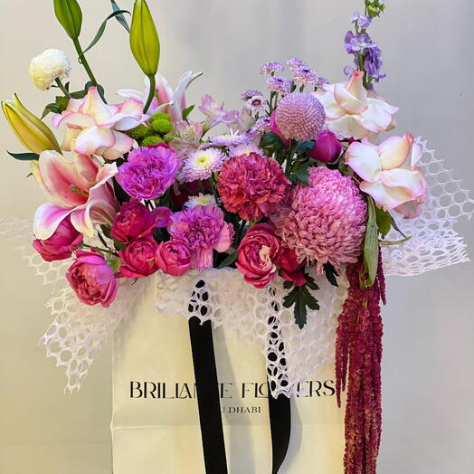 Delightful mix of pink and purple bag bouquet